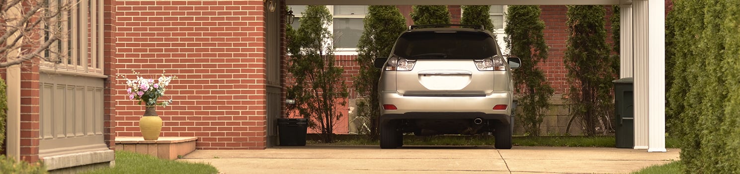 car parked under an open home parking area
