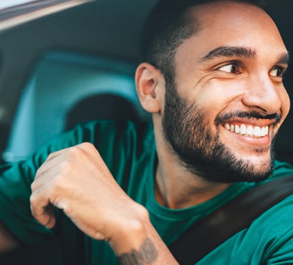 man smiling from car