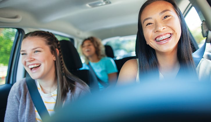 Young driver behind wheel with passengers