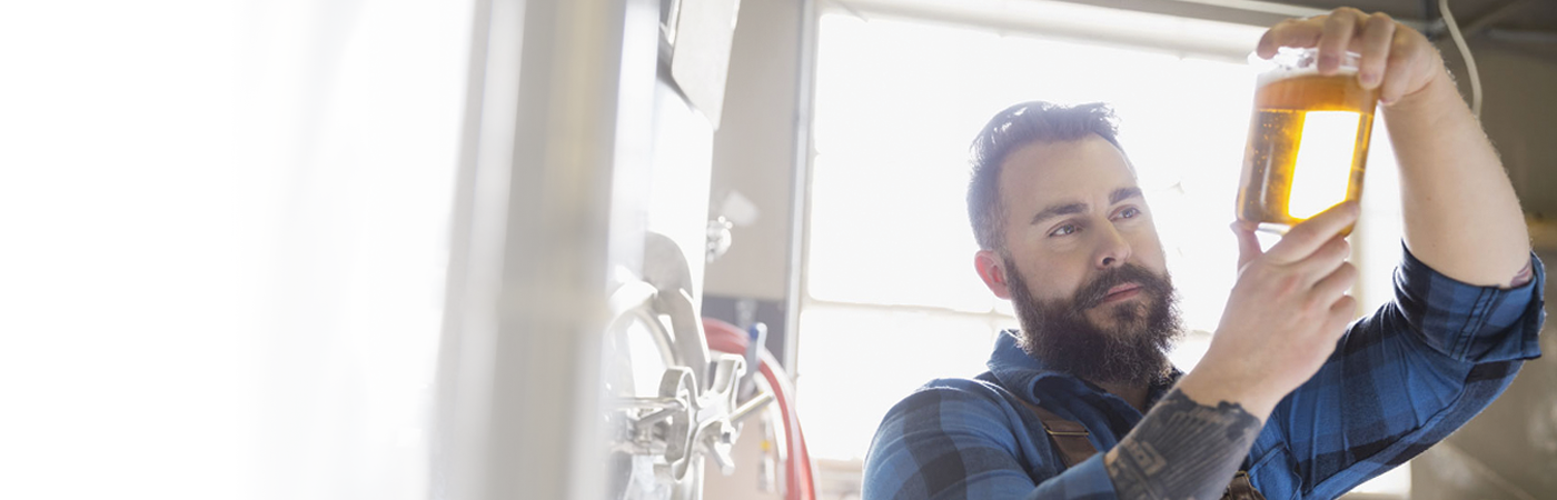 man admiring his brewing skills