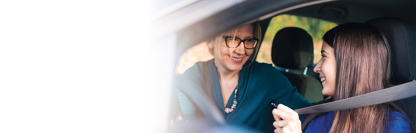 woman teaching girl to drive