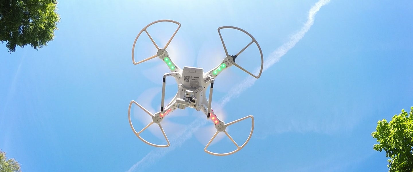 a drone in the sky being looked at from the ground