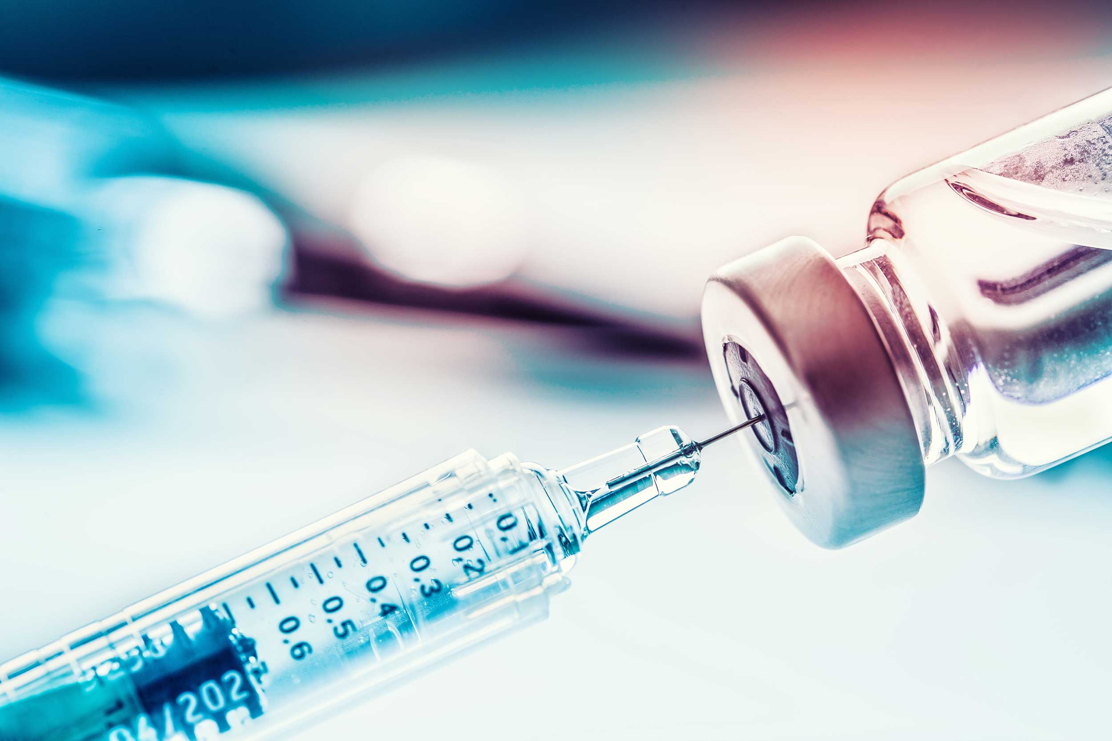 Decorative photo of a syringe and bottle with a medical liquid