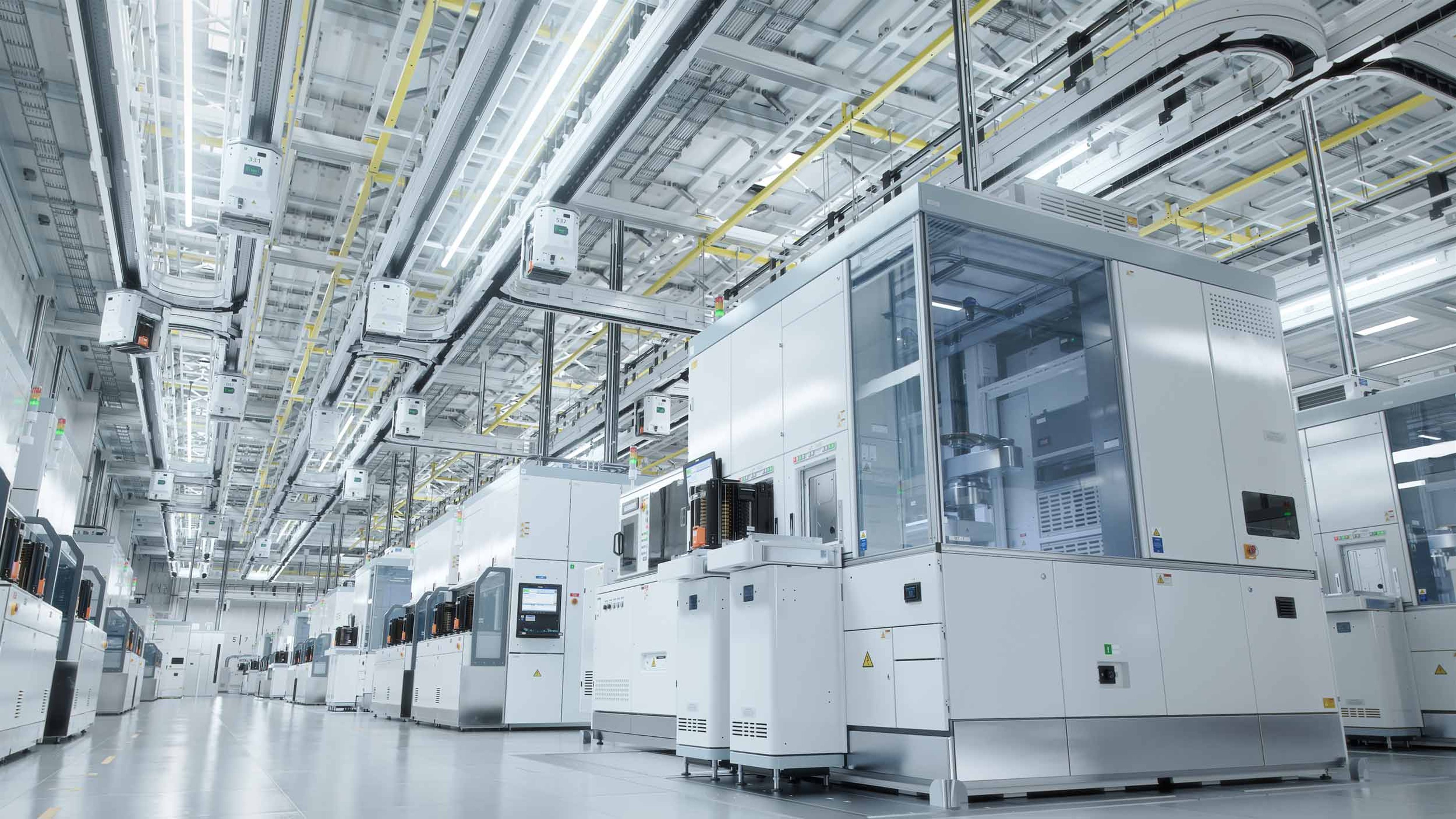 Semiconductor fab with manufacturing equipment and automated systems following tool installation and integration for chip production.
