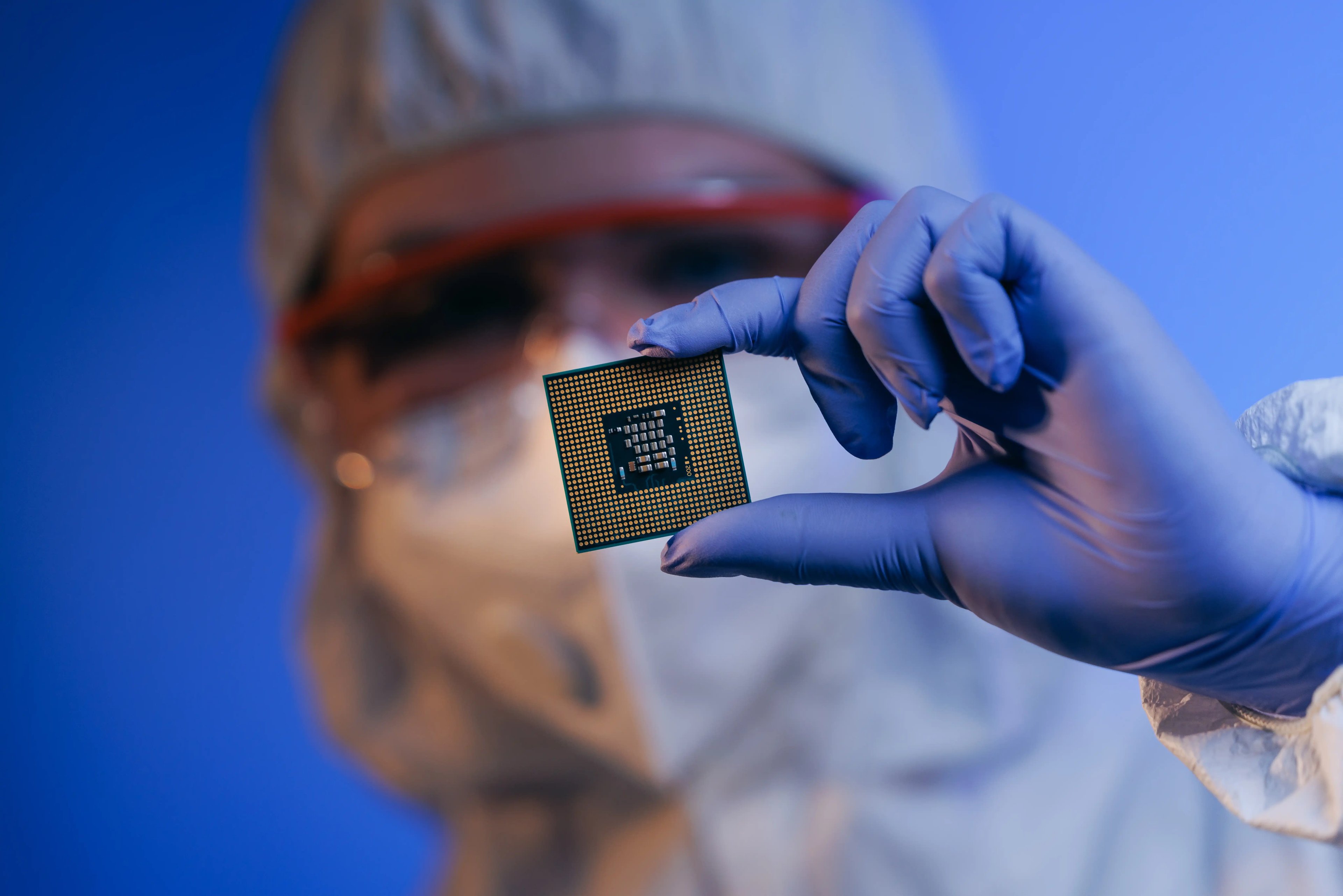 An engineer holding a semiconductor chip