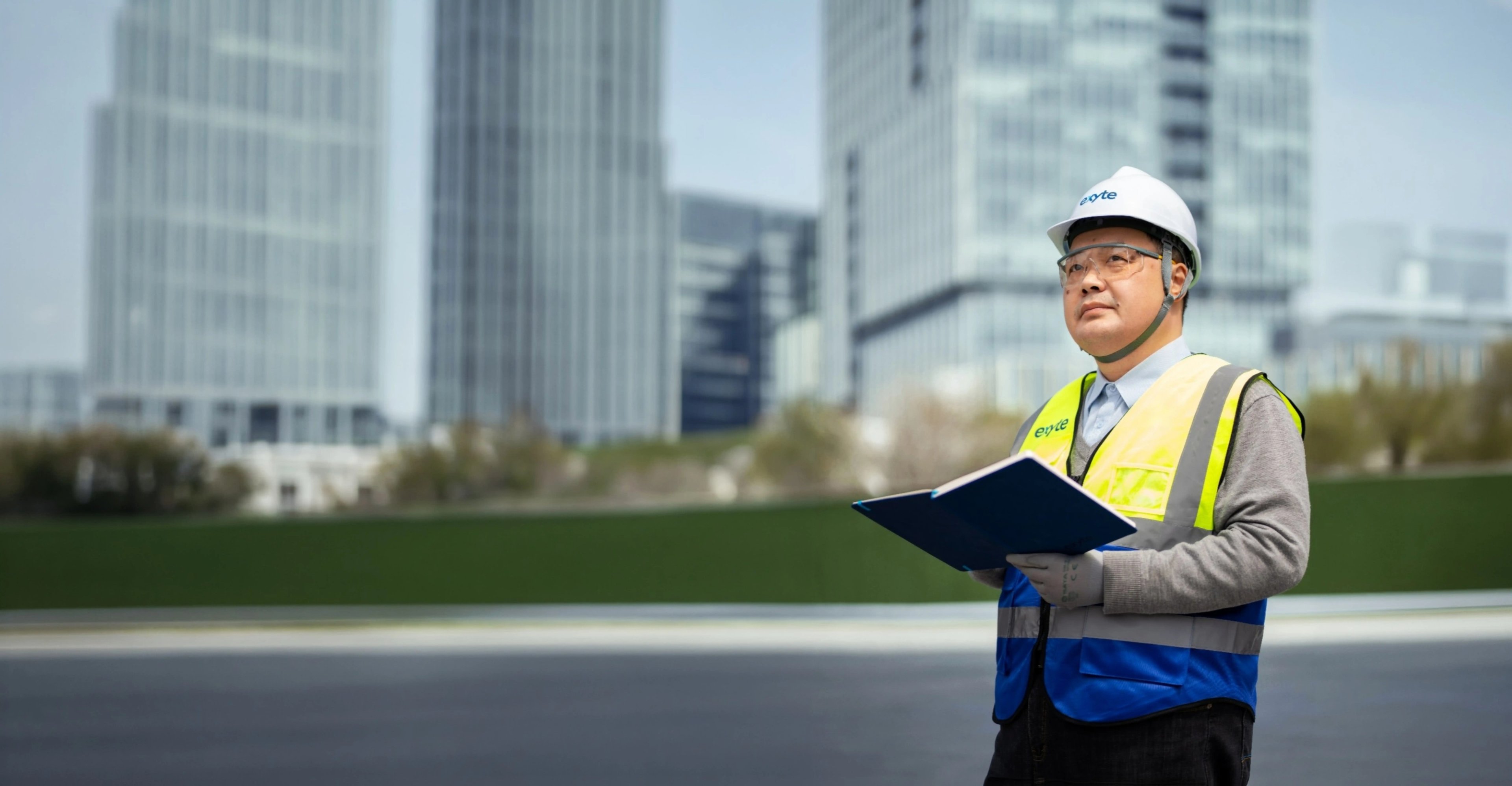 Jason Jia, an engineer, wearing a high-visibility vest, inspecting a cutting-edge facility meticulously constructed and designed by Exyte.