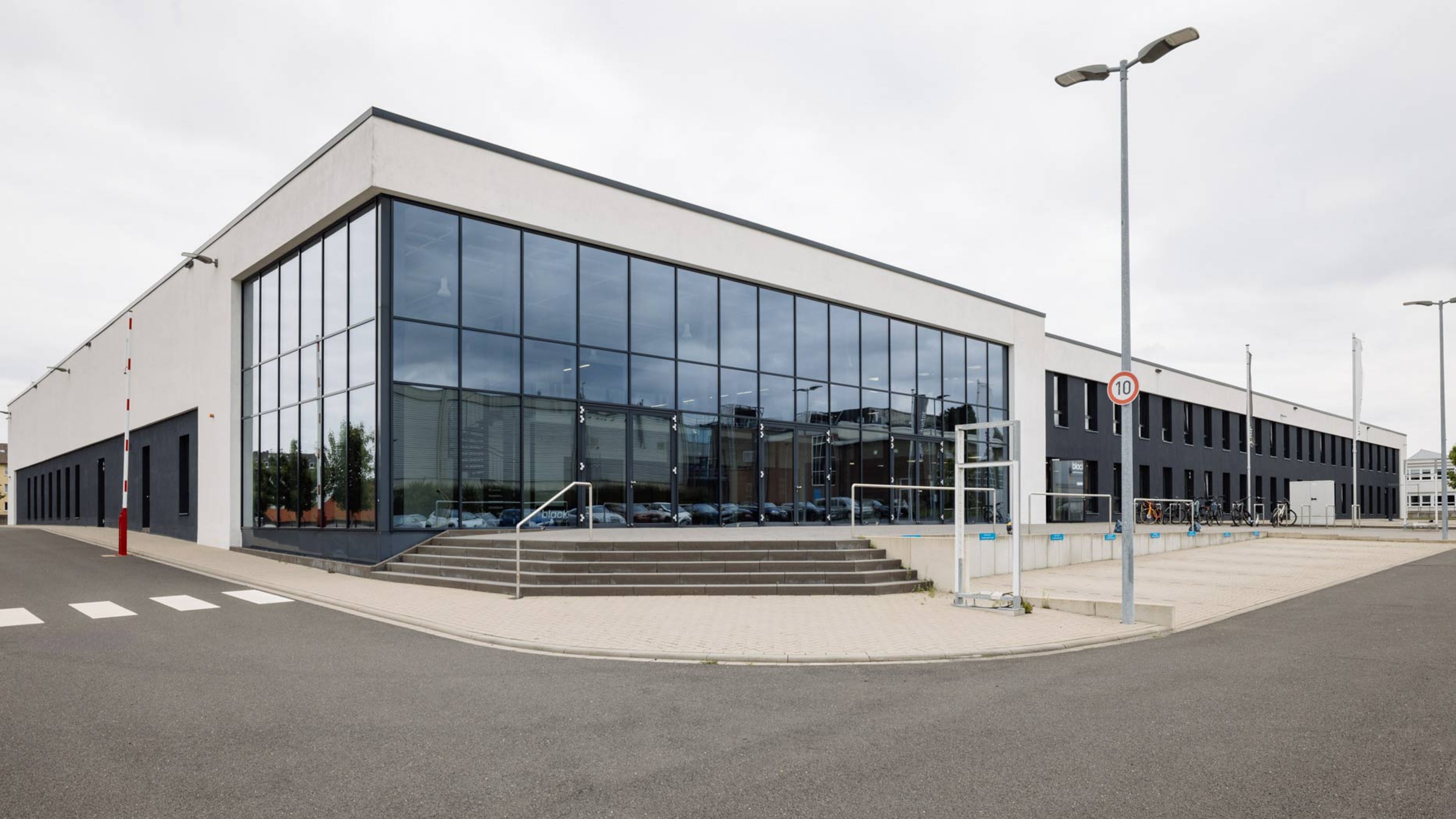 Exterior of building that was once an automotive startup in Aachen, Germany. Here Exyte is building and engineering a semiconductor fab pilot manufacturing line for Black Semiconductor
