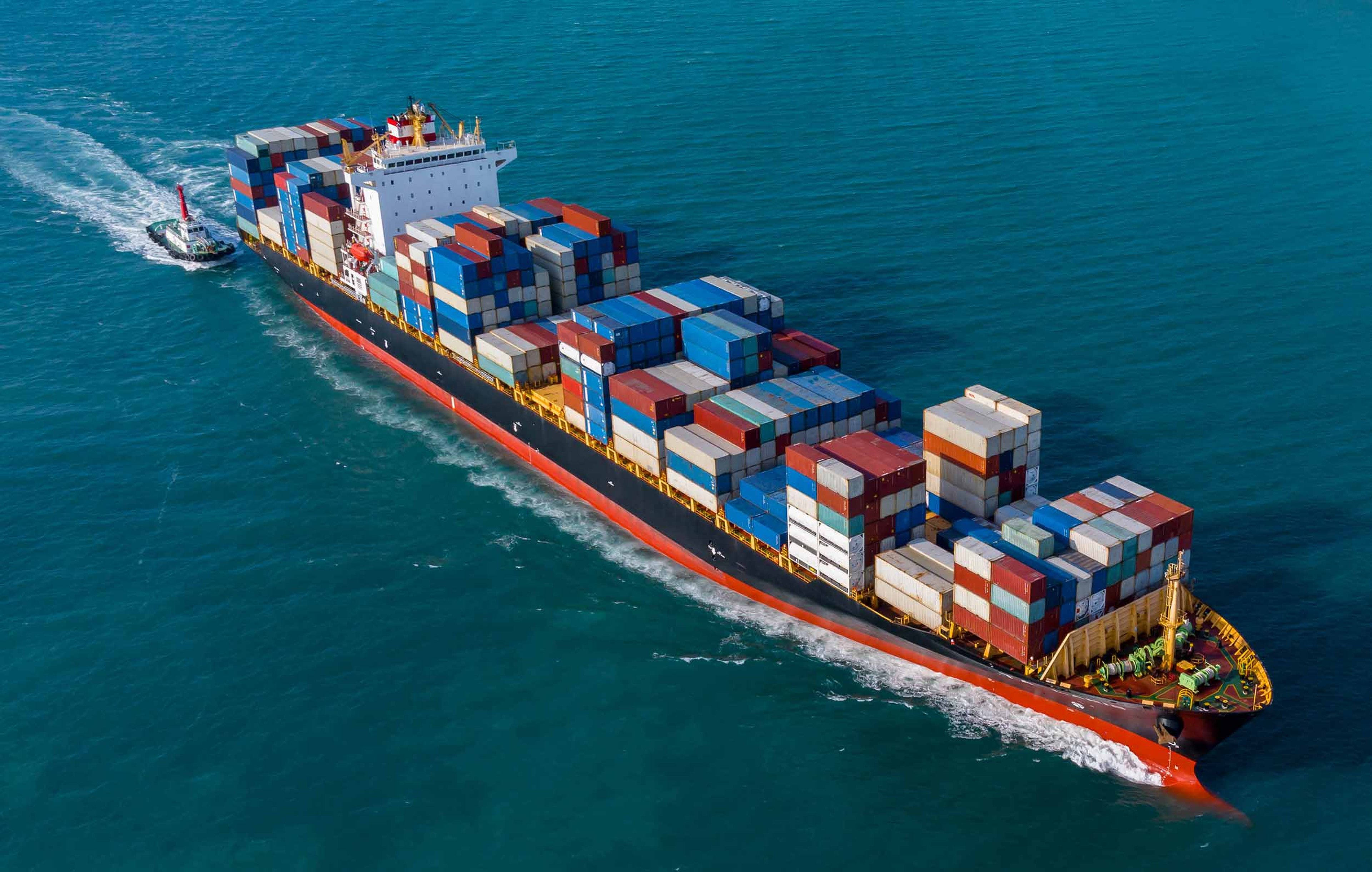 A container ship loaded with cargo containers, symbolizing global supply‑chain networks monitored by RiskWise, Exyte’s AI‑native tool that detects early signals of potential disruption for procurement teams.