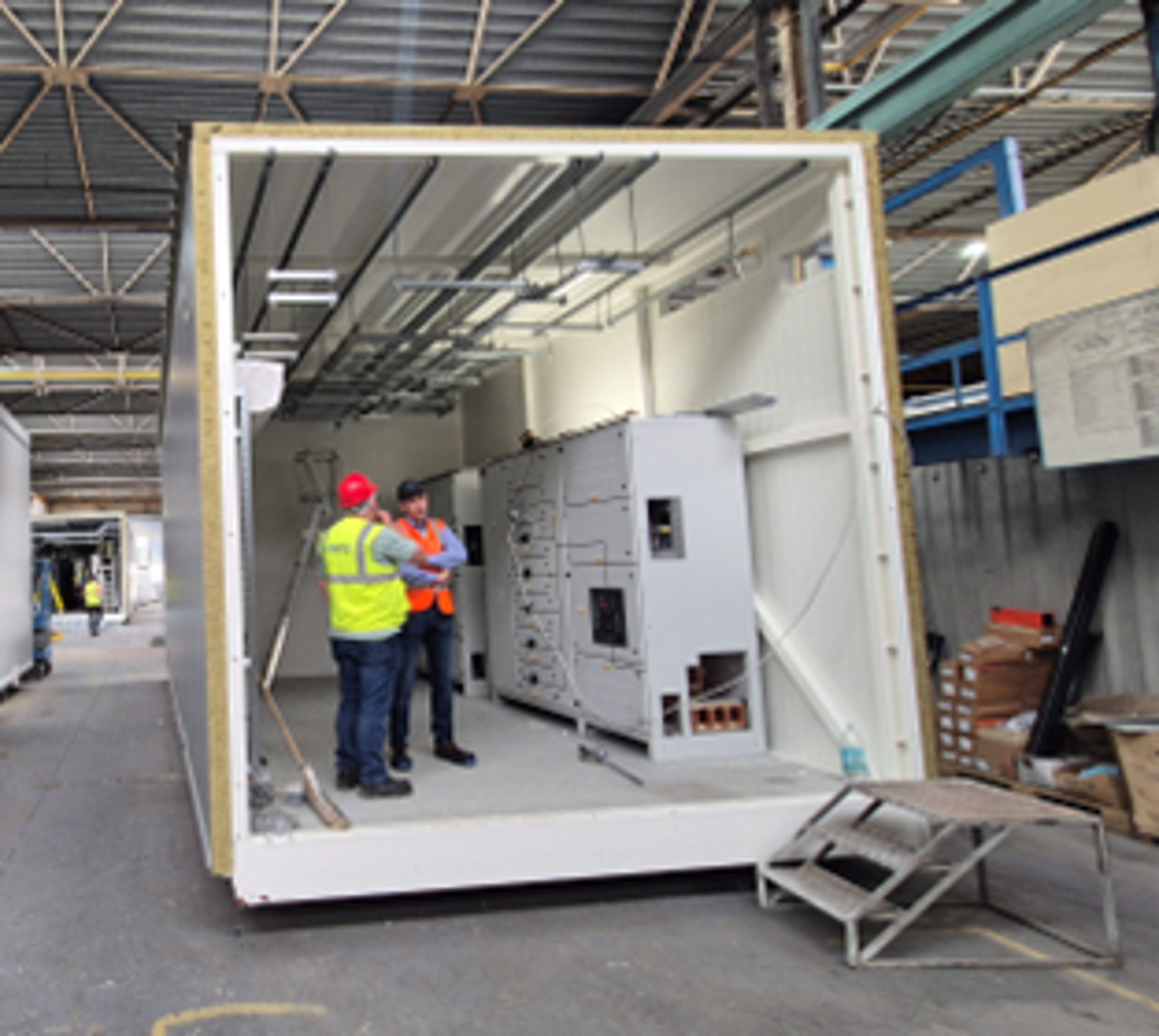 A modular data center unit is installed is shown from the inside. The unit has already been moved inside the facility and is ready to be installed by Exyte engineers on a data center project in Germany.