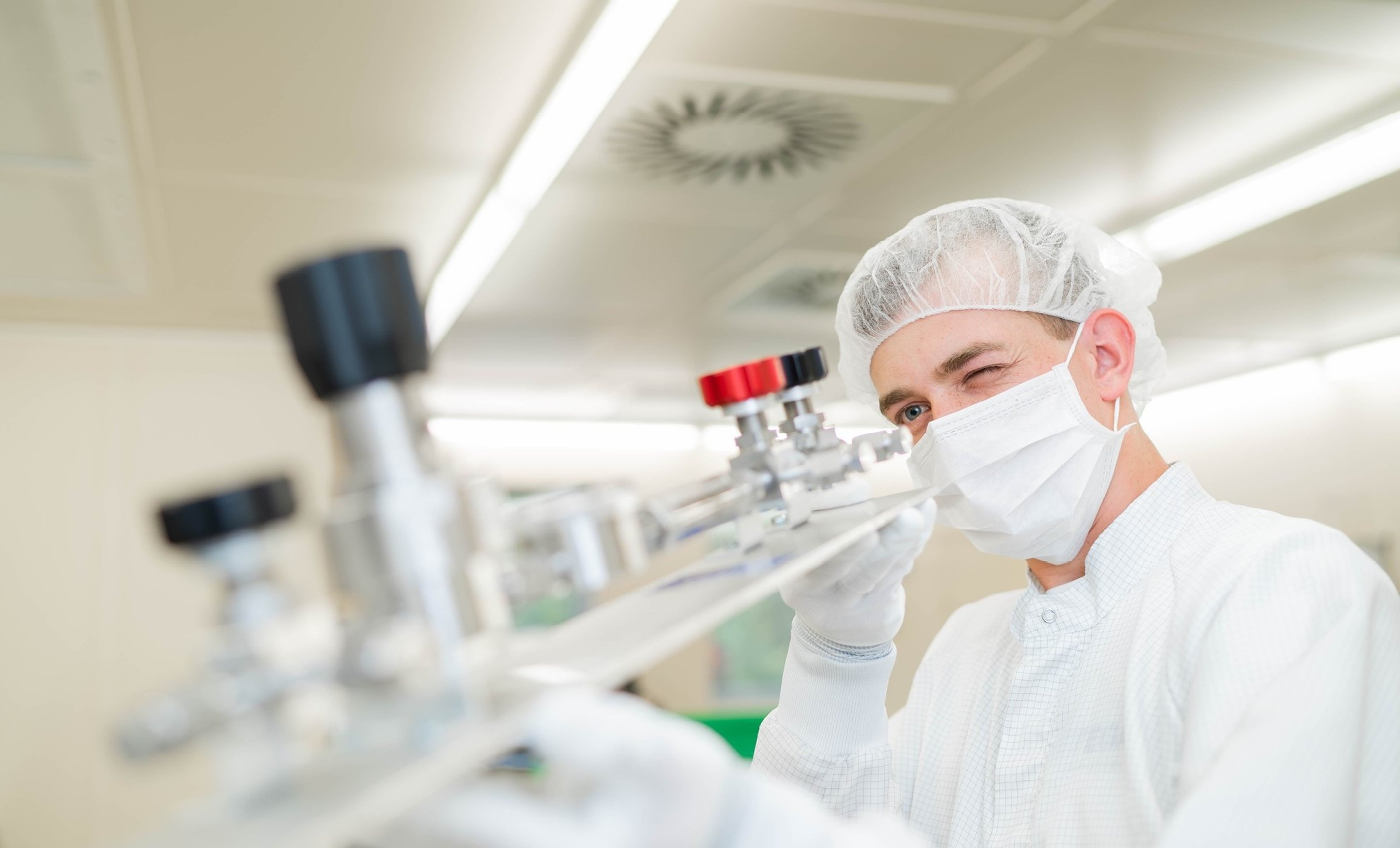 Employee of Exyte subsidiary Intega inspecting a piece of high purity media equipment