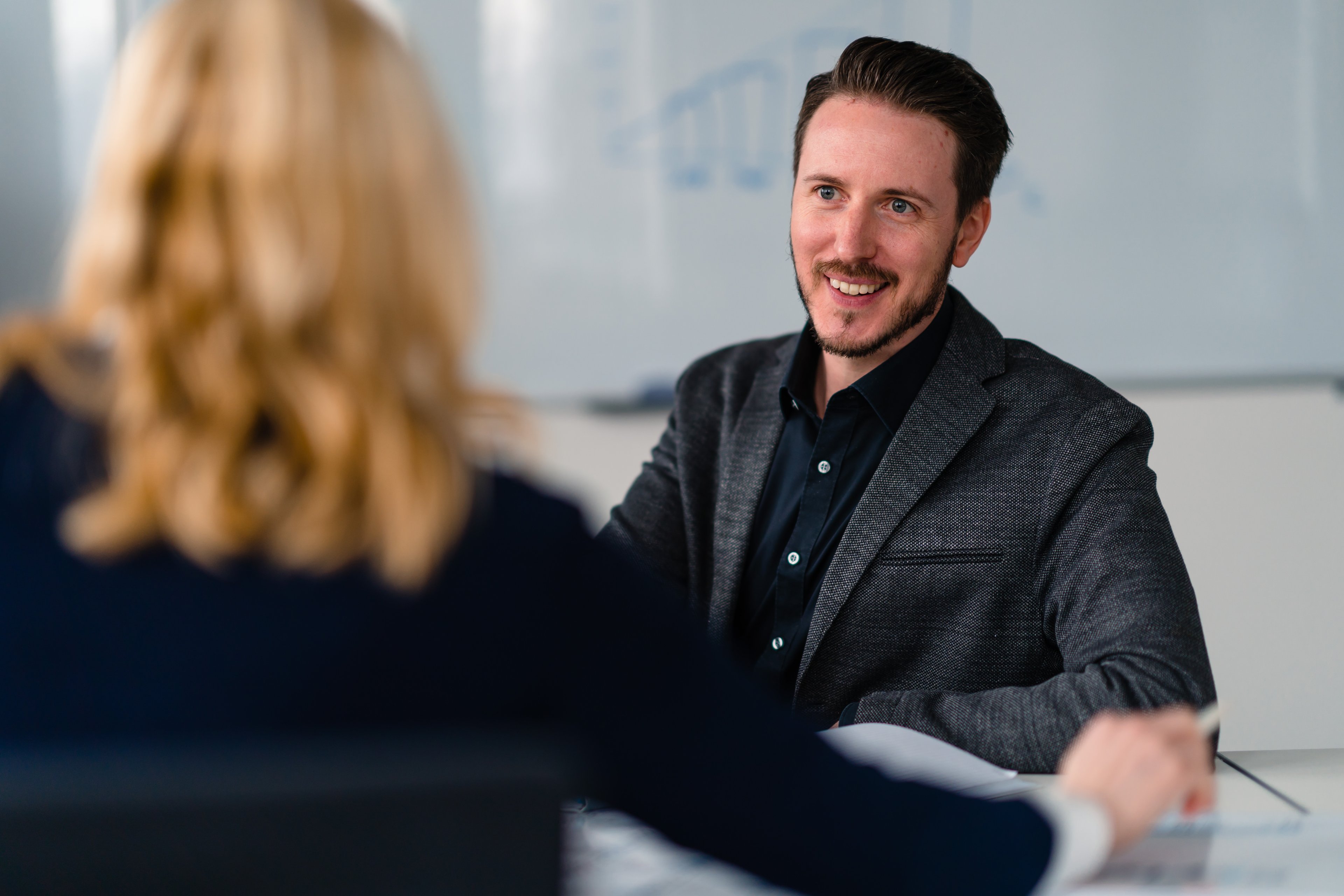 Two Exyte employees in conversation in an office