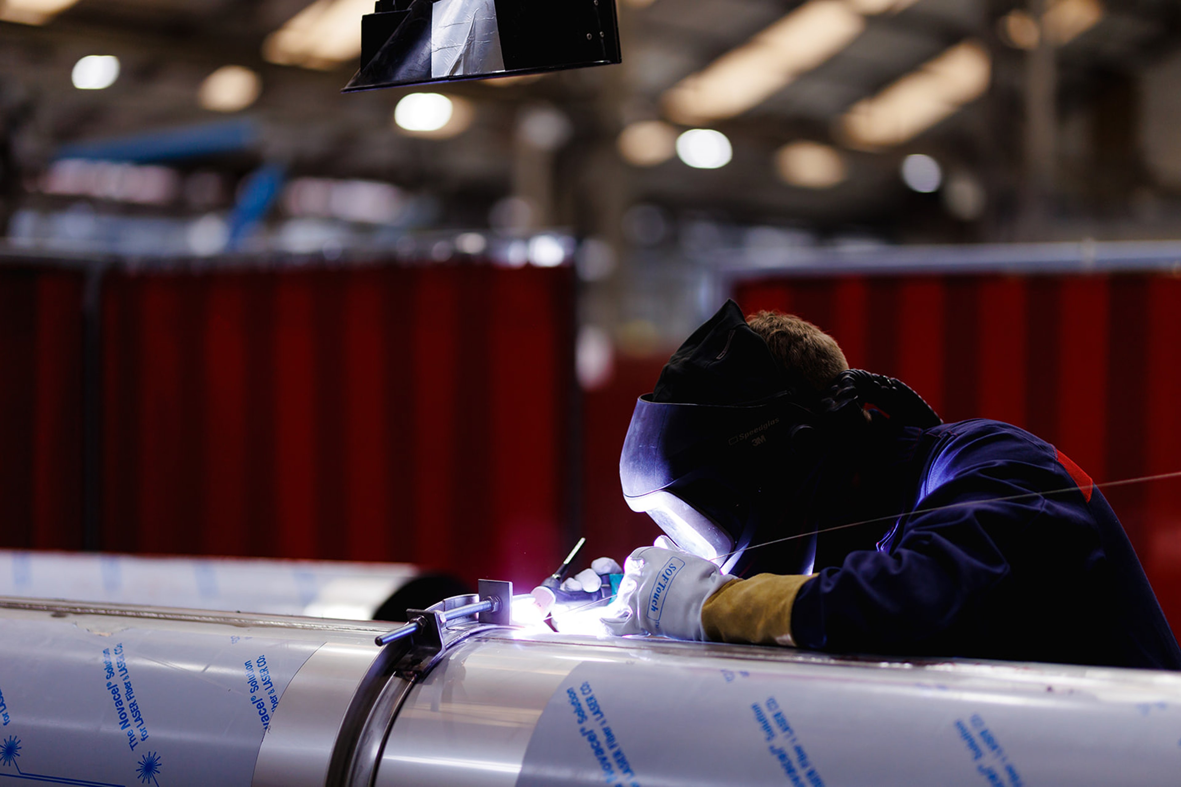 Employee of Exyte Hargreaves with safety gear doing a welding job