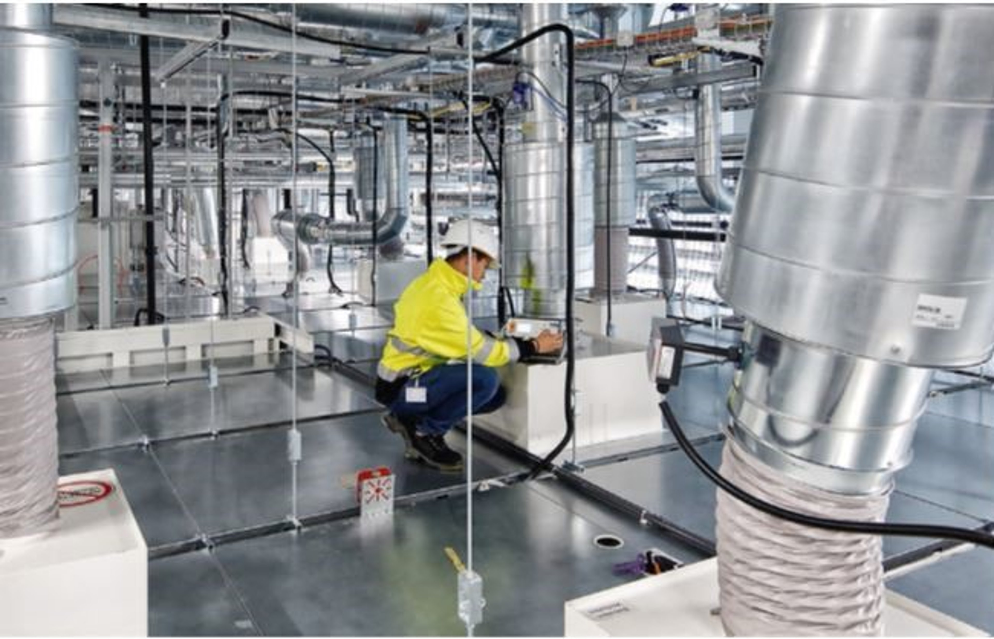 Exyte technician is looking at pipes of a HVAC system