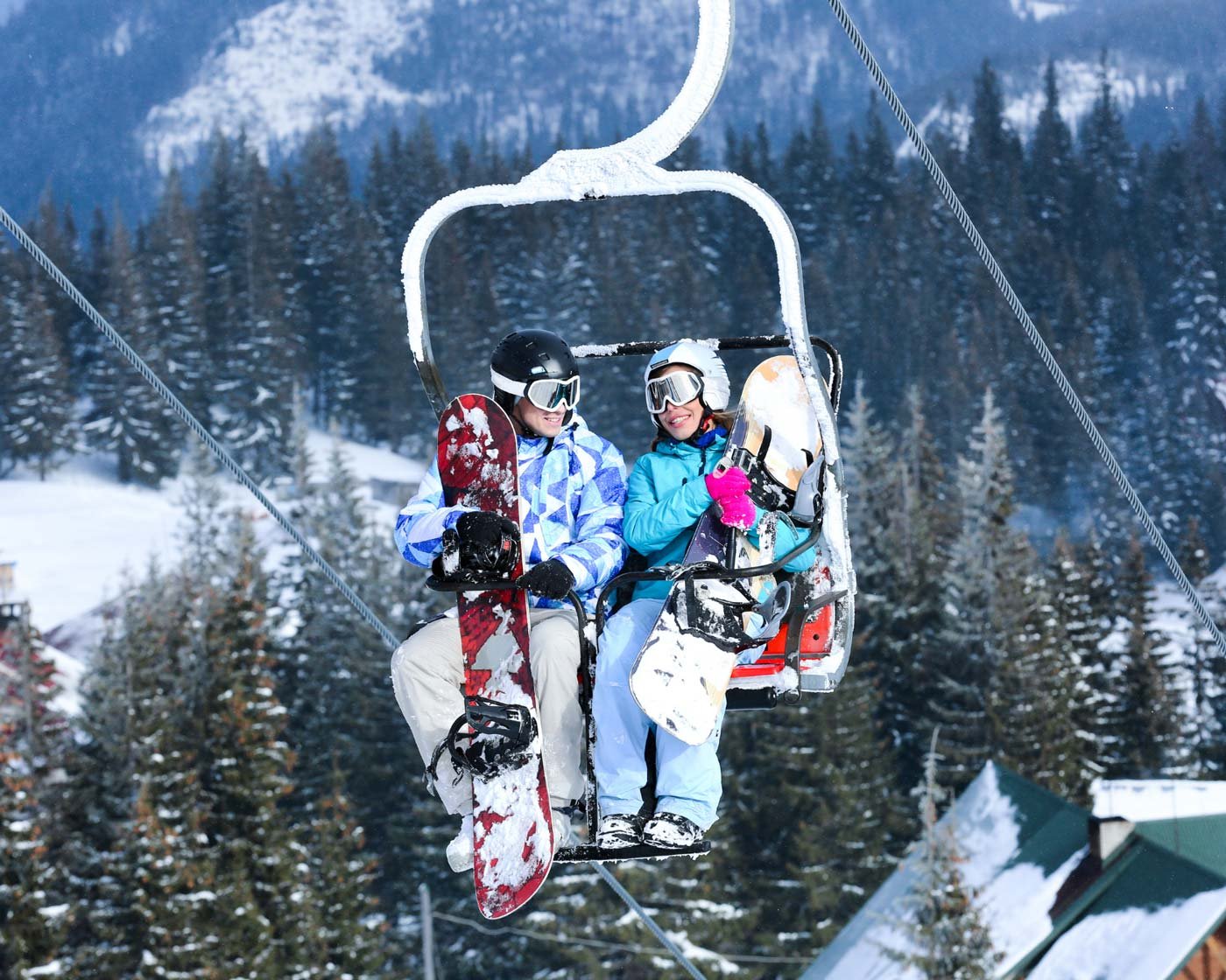 Two snowboarders on a chairlift
