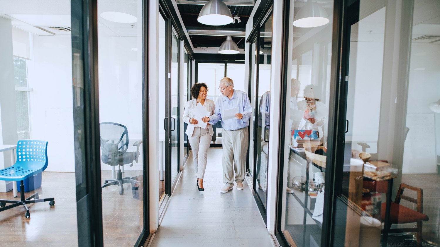 Man and women walking together in an office
