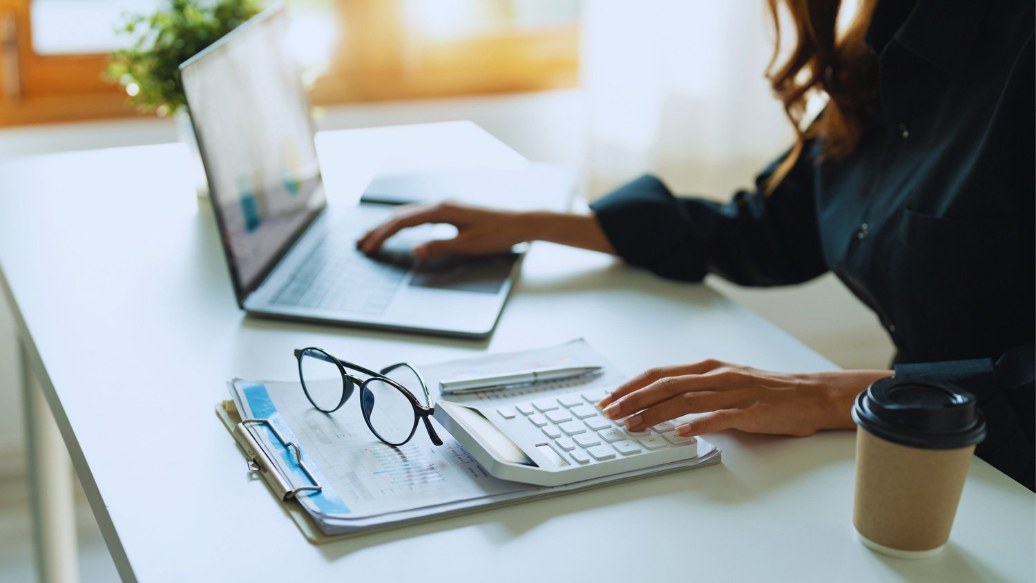 Solo female accountant working at computer