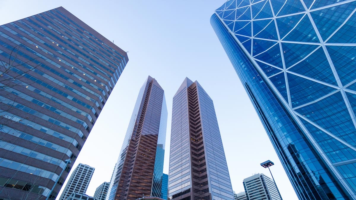 A view of Calgary's modern skyline featuring skyscrapers and architectural diversity under a clear sky.