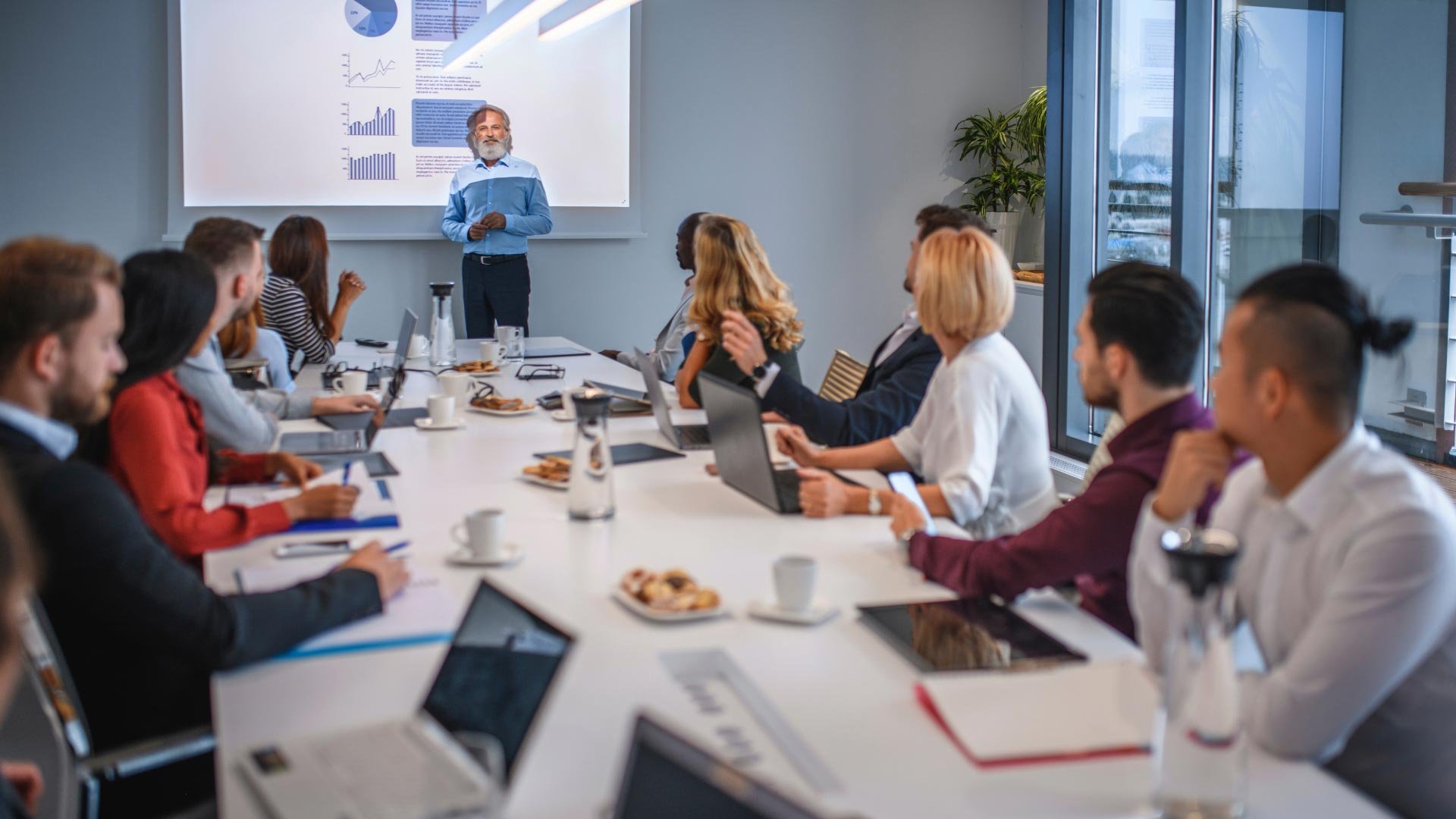 Diverse group of professionals engaged in a business meeting in a modern conference room.