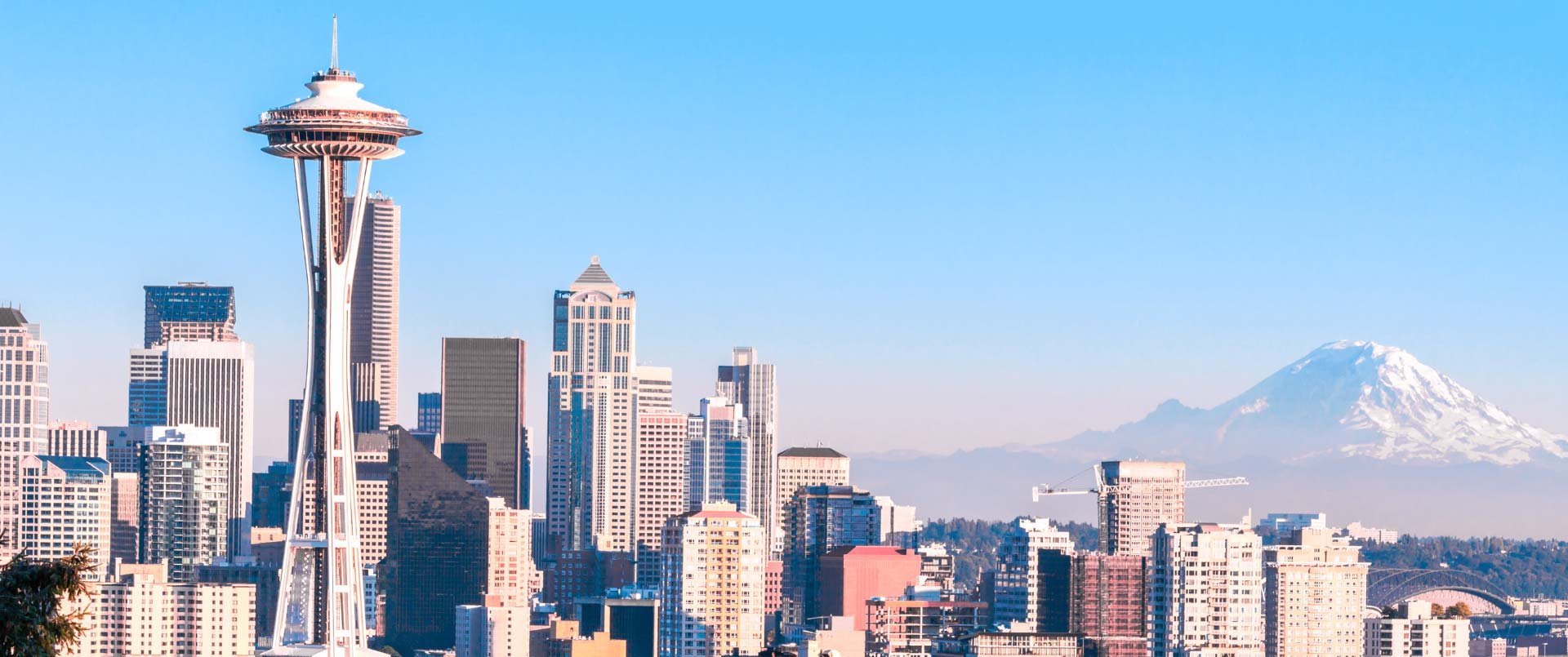 Panoramic view of Seattle's iconic skyline featuring the Space Needle and Mount Rainier in the background
