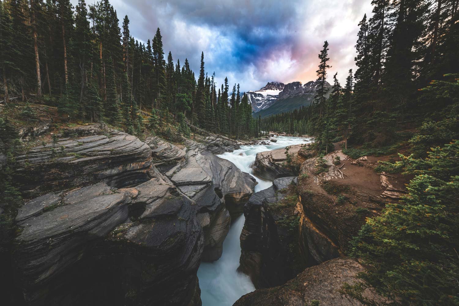 Panoramic view of a river winding through a mountainous landscape with visible fire damage