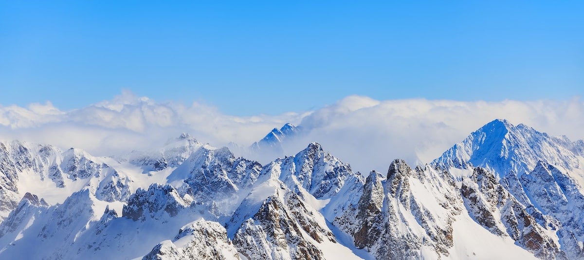 Clear blue skies over snowy mountains