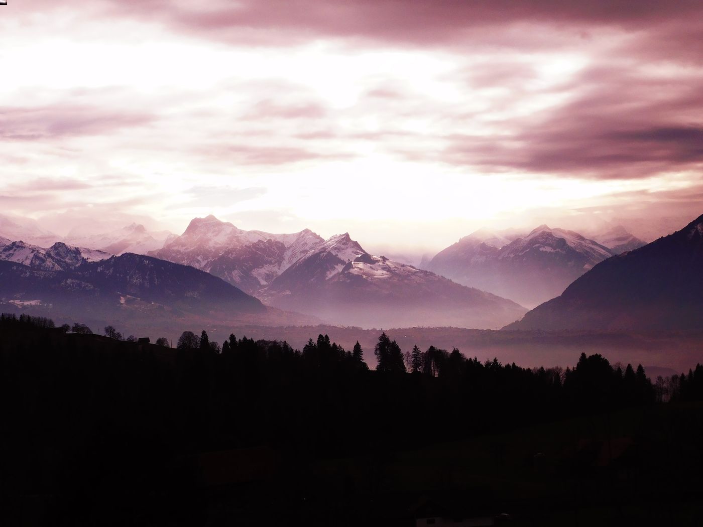 Cloudy mountain sunset in the forest