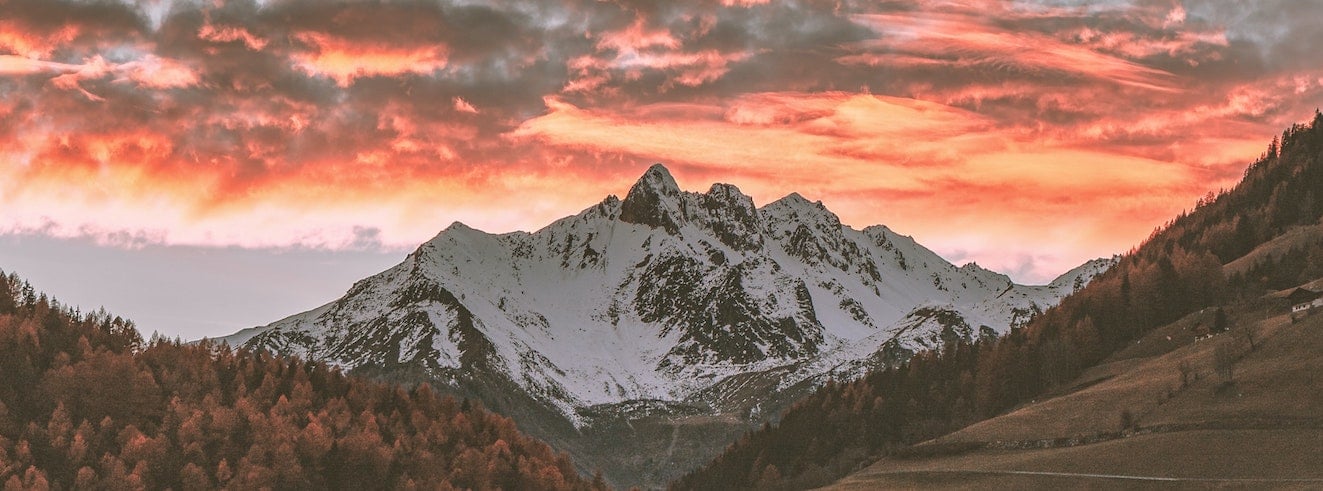 A dramatic sunset behind a mountainscape