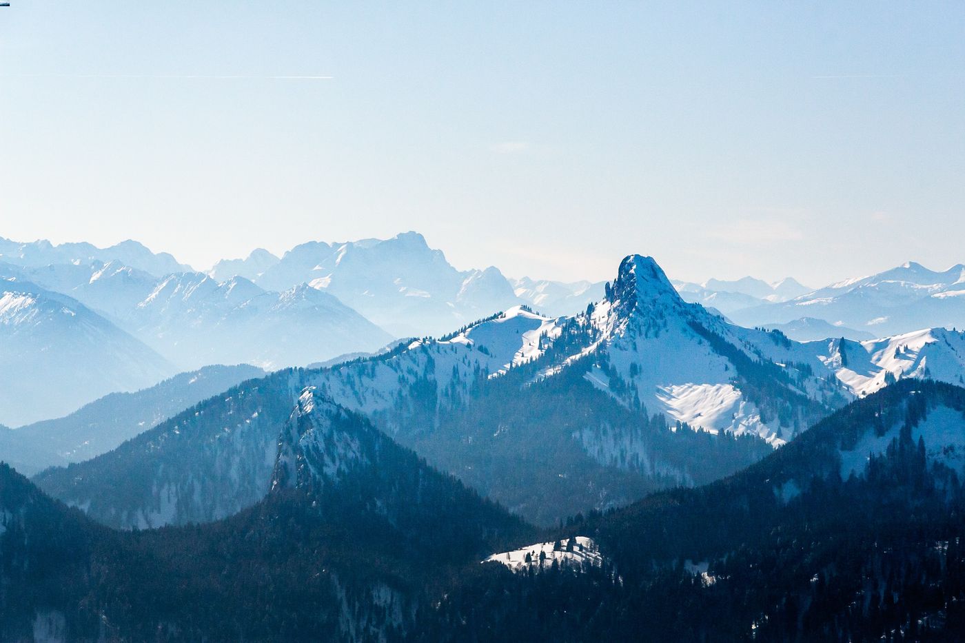 Foggy mountain landscape with snow capped peaks