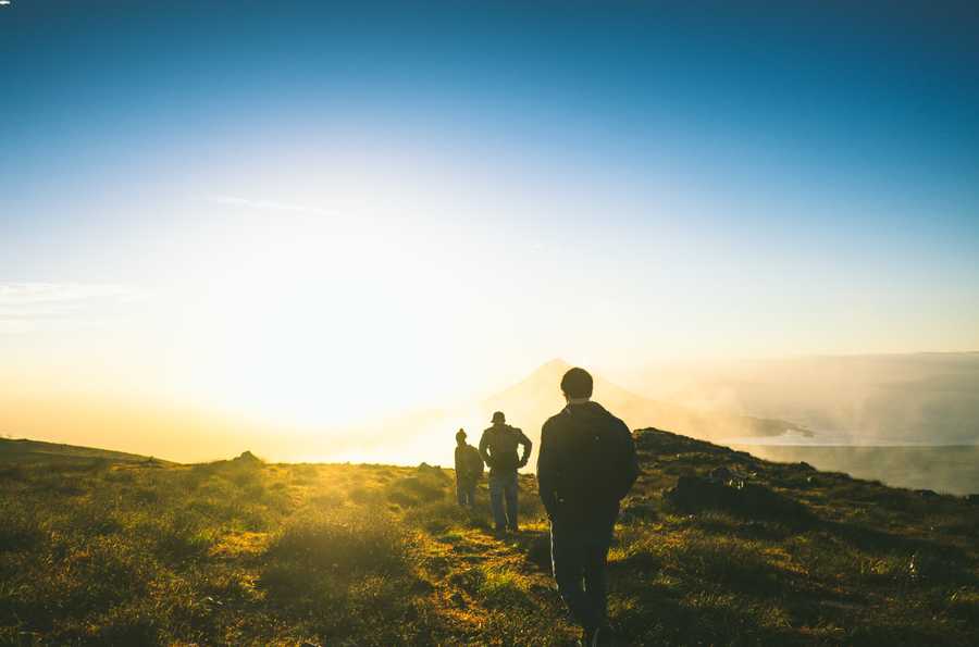 A group of hikers at sunrise.