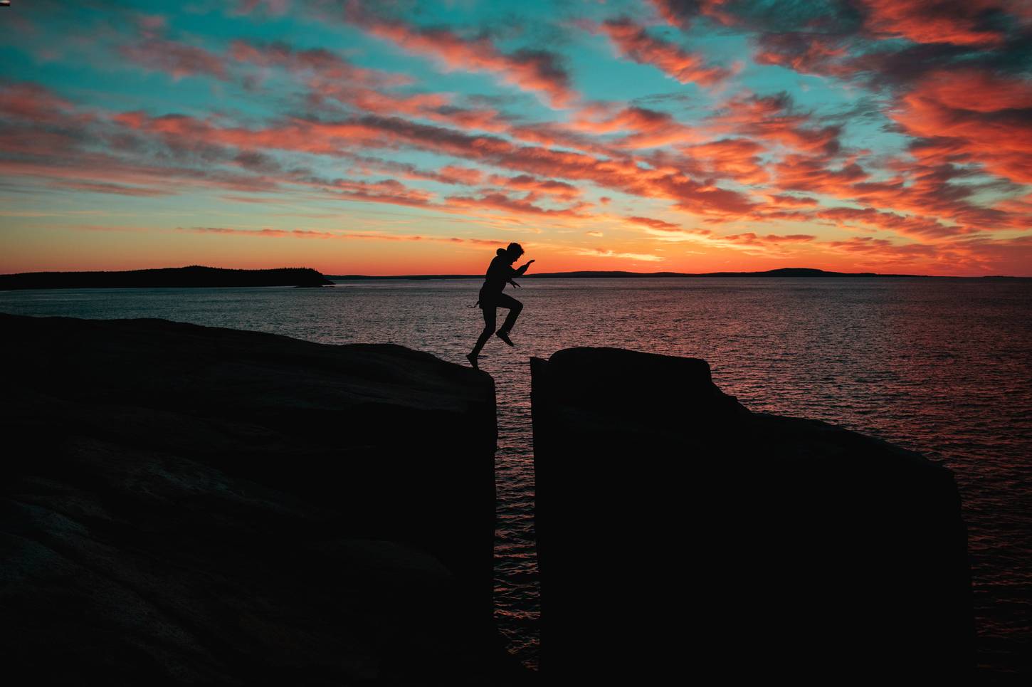 Sunset with man on a cliff