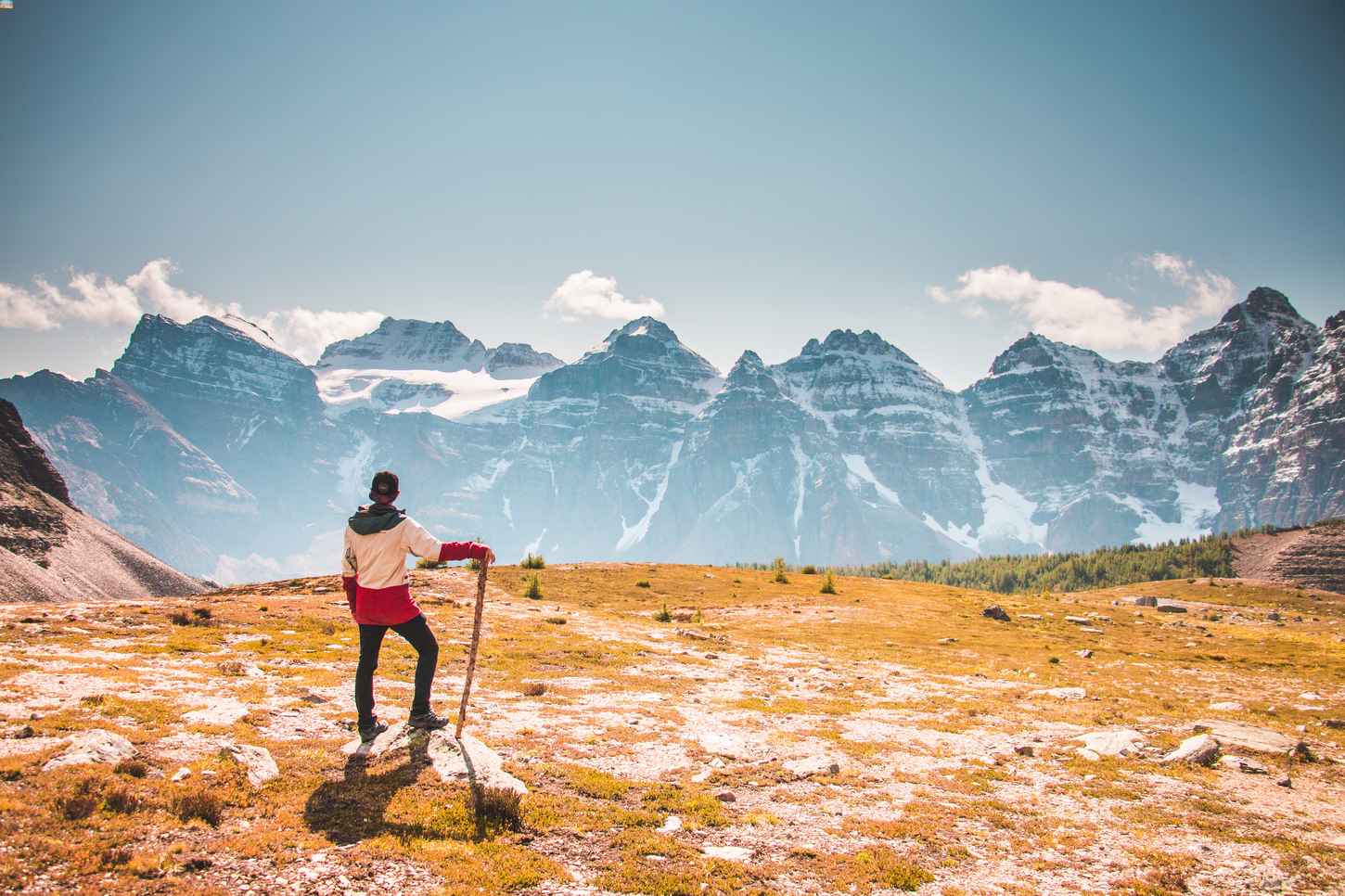 A man hiking and looking at the mountains