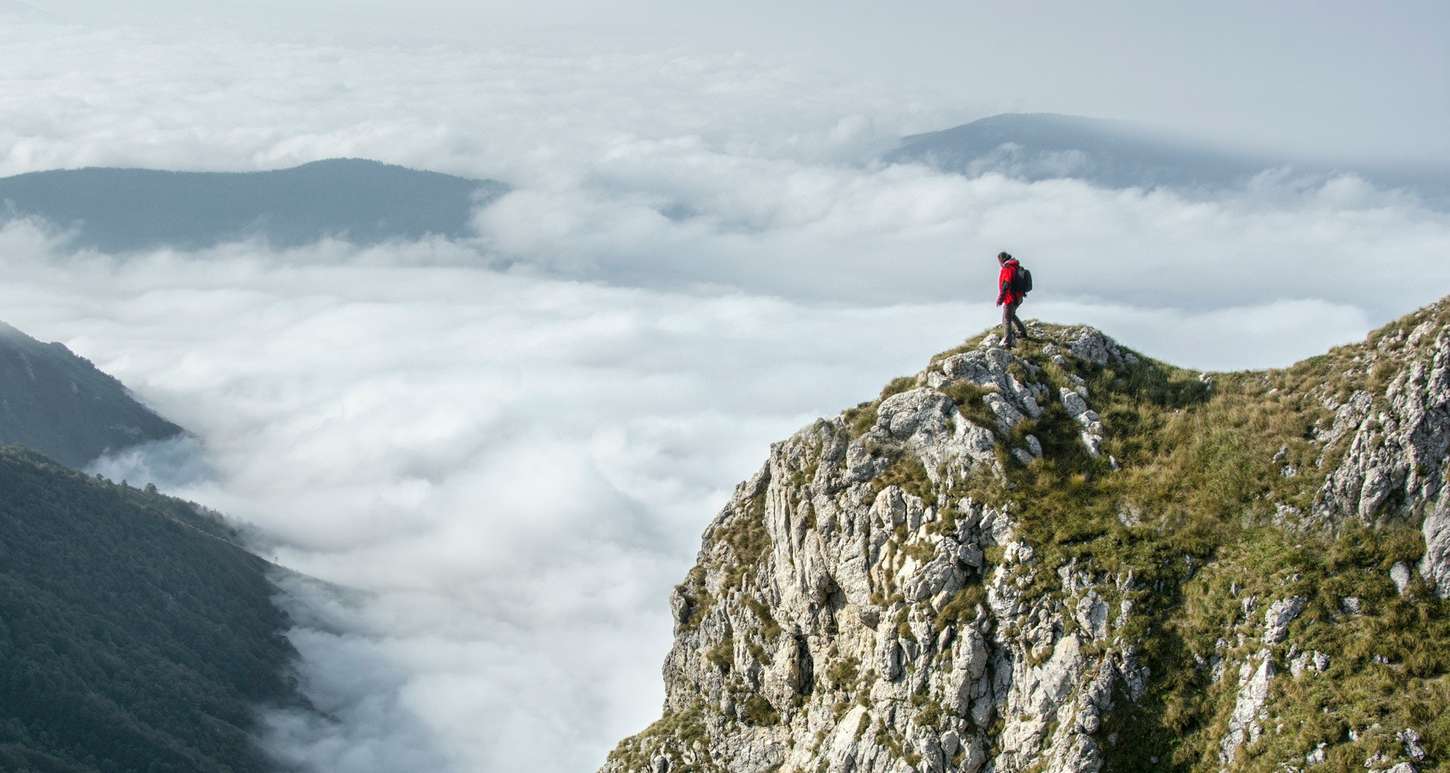 Man on edge of a cliff hiking