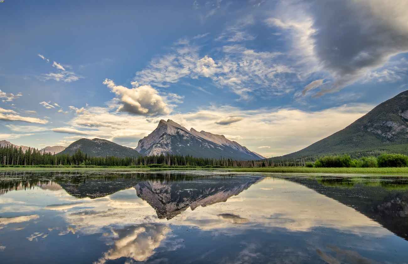 Reflections of mountains on a calm lake.