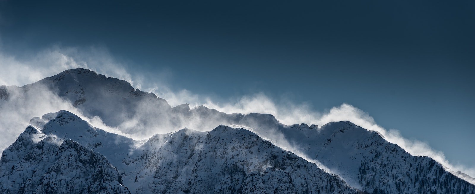 Mountain with snow blowing off the peaks