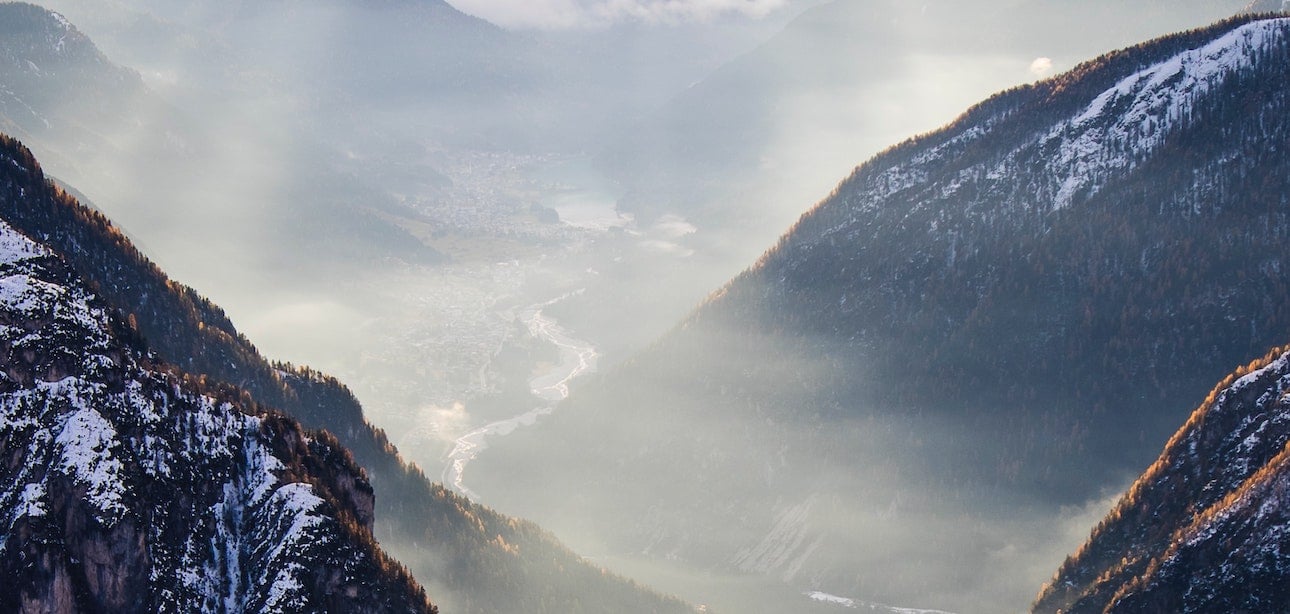 Sun rays peaking through a misty mountain scape