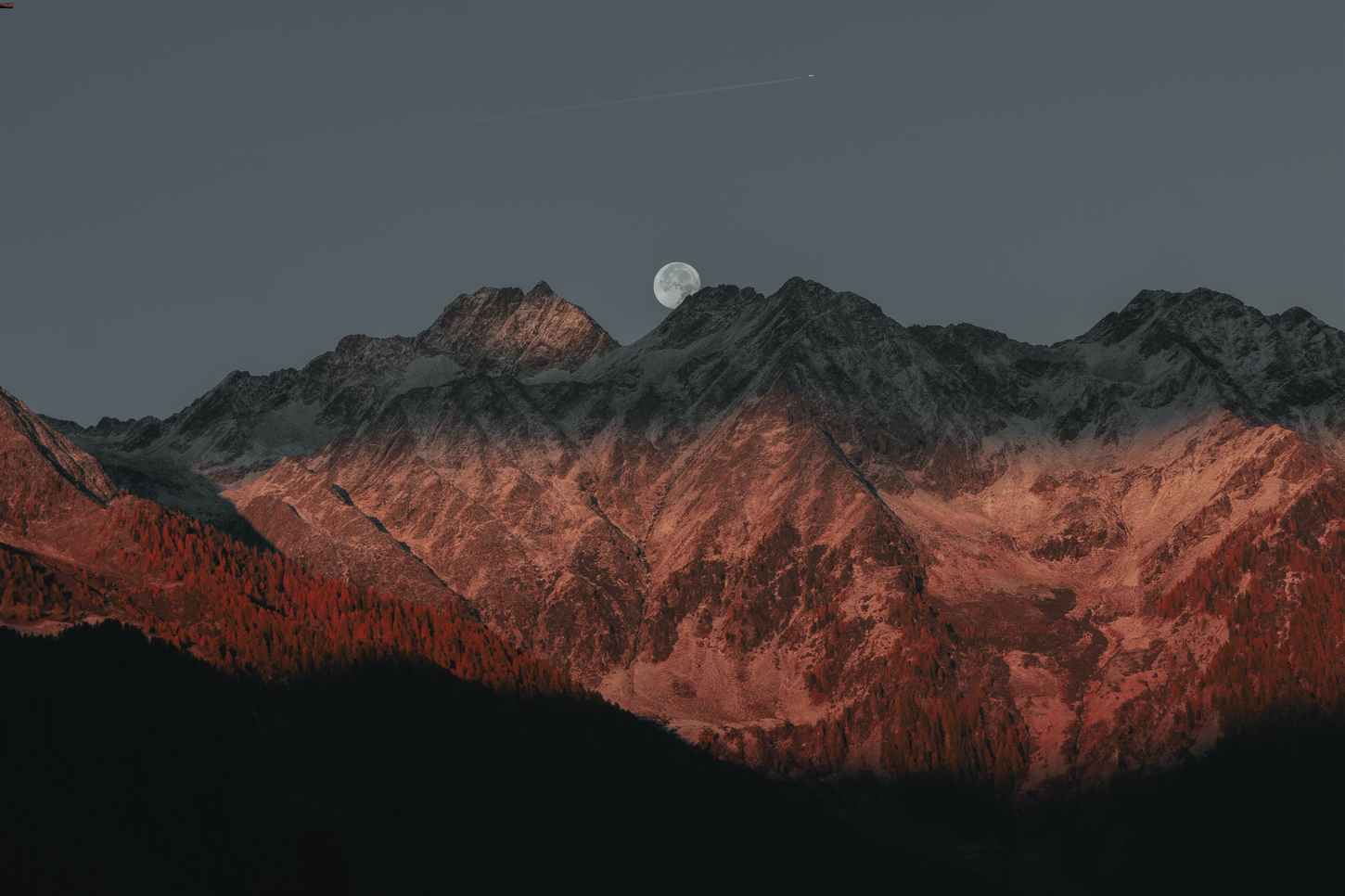 Moon behind mountains