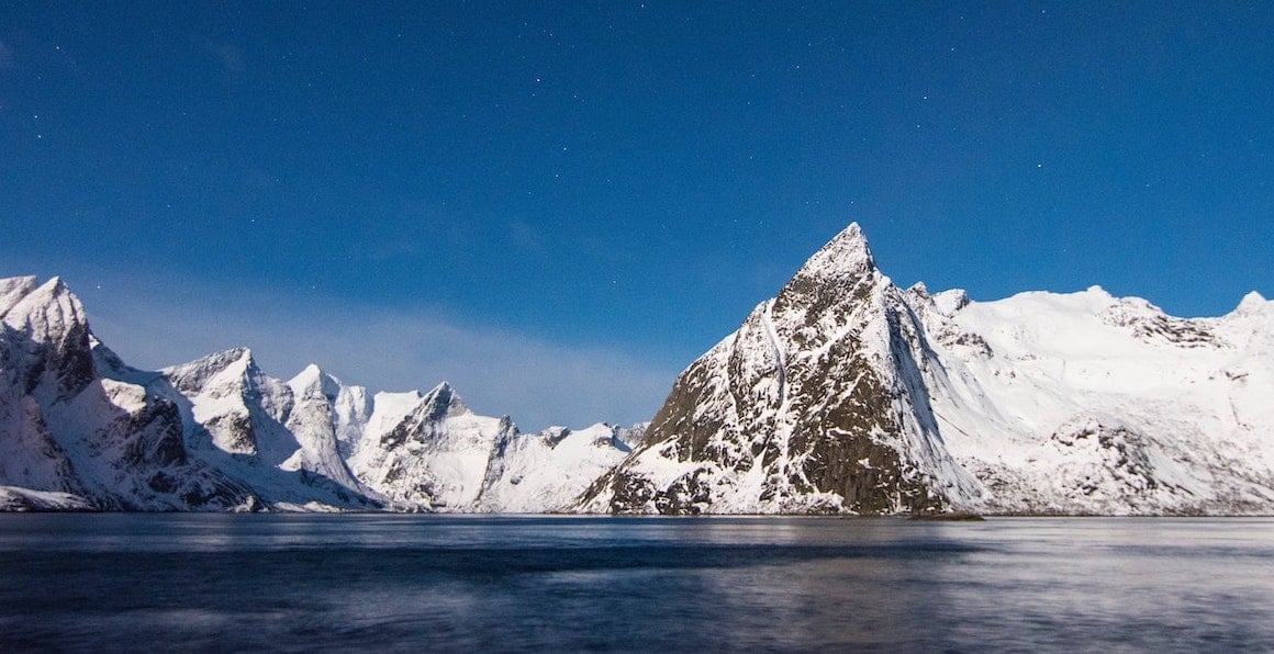 Stars over top of a mountain lake