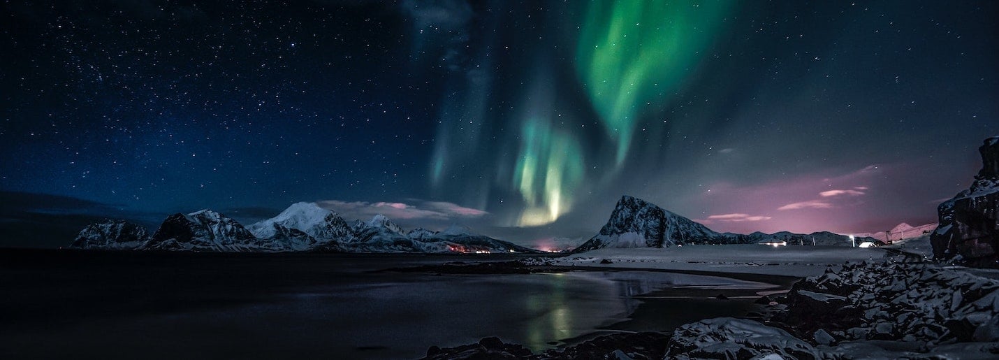 Northern lights over a mountain lake