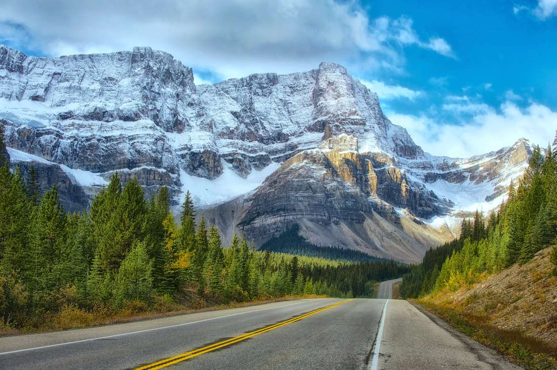 Road through snow capped mountains