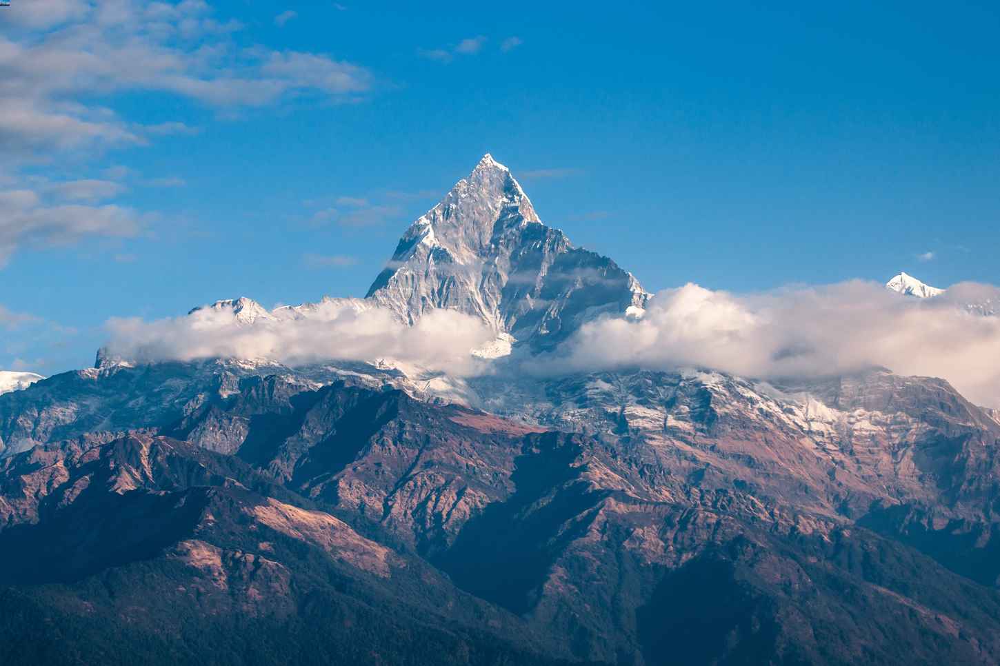 Mountain summit with clouds around it
