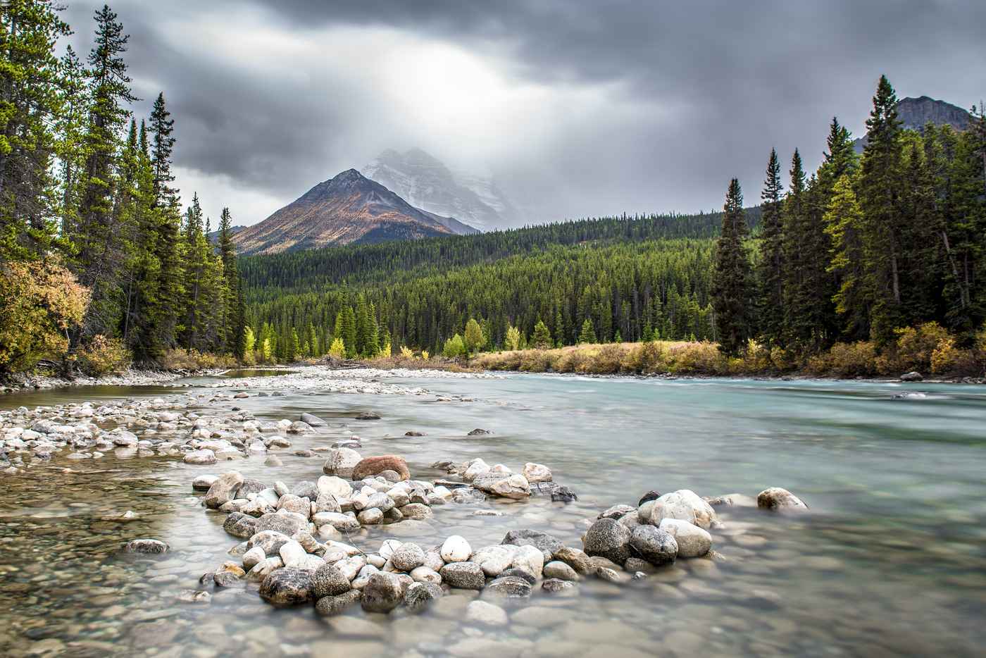 River in front of a mountain in Alberta