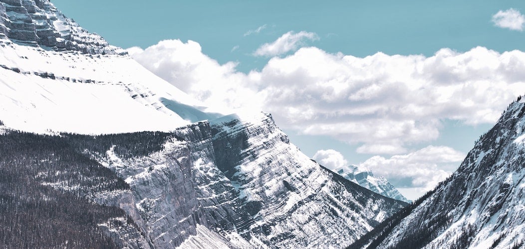 Cloudy sky with a snow capped mountain 