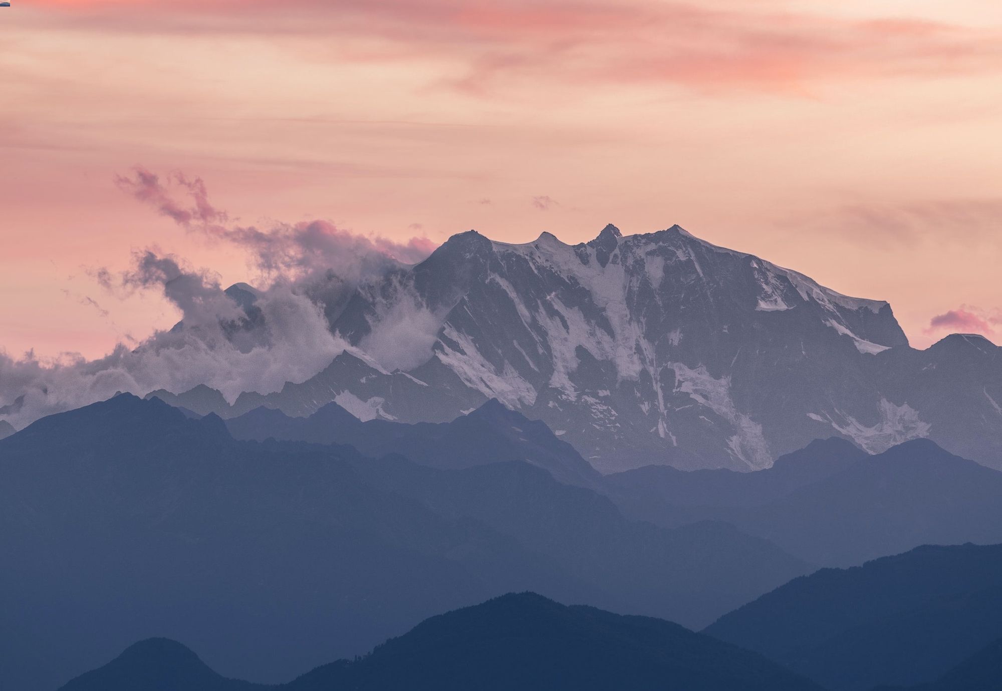 Pink sunset over a misty mountain range 