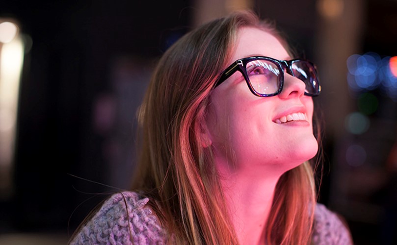 A person smiling with glasses