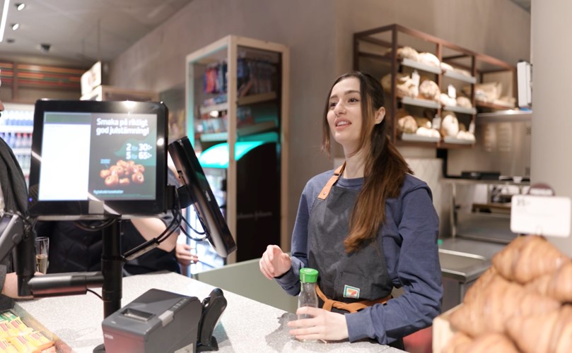 A woman stands at a retail counter