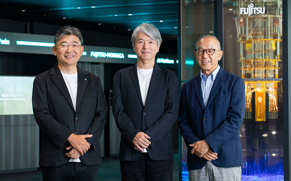 Three speakers standing for an article on Trust in AI