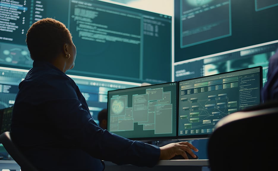 Cybersecurity experts working in IT security are monitoring network security, AI, and data.