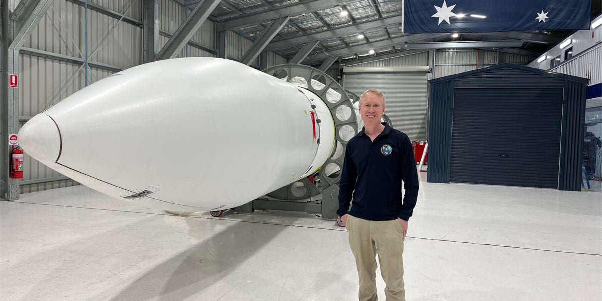 Gilmour Space Technologies co-founder and CEO Adam Gilmour beside the fully assembled, Australian-made Eris orbital rocket
