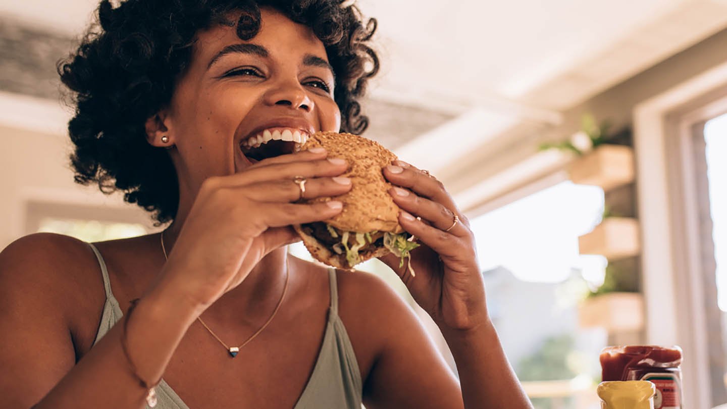 restaurants-lady-eating-burger-1440x810