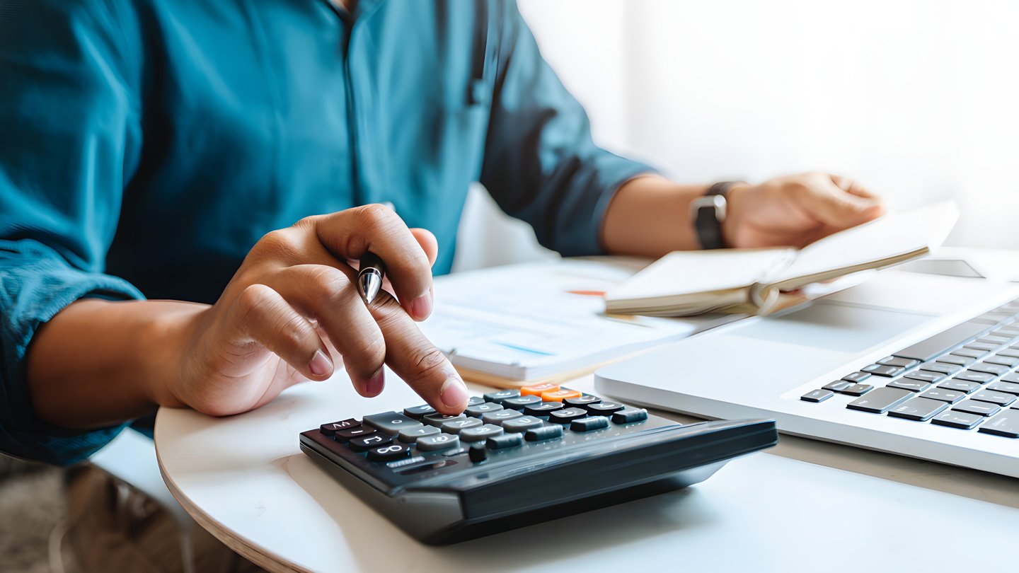 1440x810-hand-on-calculator-adding-up